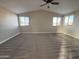 Large bedroom featuring plush carpeting, large windows and a high, vaulted ceiling at 1010 N Osprey Ct, Gilbert, AZ 85234