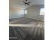 Bedroom with vaulted ceilings, ceiling fan, carpeting, and large windows for natural light at 1010 N Osprey Ct, Gilbert, AZ 85234