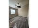 Light and bright room with carpeting, ceiling fan, and a sunny window at 1010 N Osprey Ct, Gilbert, AZ 85234