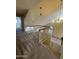 Wide carpeted hallway and staircase featuring a modern railing and beautiful lighting fixtures at 1010 N Osprey Ct, Gilbert, AZ 85234