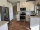 Modern kitchen featuring stainless steel appliances, white cabinetry, and stylish tile backsplash at 1010 N Osprey Ct, Gilbert, AZ 85234