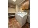 Functional laundry room with tile flooring, washer, dryer, and storage shelves at 1010 N Osprey Ct, Gilbert, AZ 85234