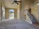 Spacious living room with high ceilings, carpet flooring, and staircase to second floor at 1010 N Osprey Ct, Gilbert, AZ 85234