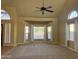 Spacious living room with high ceilings, plush carpeting, and large windows offering ample natural light at 1010 N Osprey Ct, Gilbert, AZ 85234