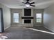 Cozy living room featuring a white brick fireplace and two windows letting in plenty of natural light at 1010 N Osprey Ct, Gilbert, AZ 85234