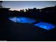 Backyard pool and spa illuminated with blue lights at night at 1010 N Osprey Ct, Gilbert, AZ 85234
