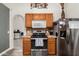 Functional kitchen with stainless steel appliances and views of the living area at 10211 W Hazelwood Ave, Phoenix, AZ 85037