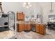 Functional kitchen with wood cabinets, and views of the dining area at 10211 W Hazelwood Ave, Phoenix, AZ 85037