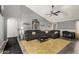 Spacious living room with vaulted ceiling, comfortable seating, and modern ceiling fan at 10211 W Hazelwood Ave, Phoenix, AZ 85037