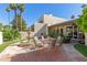 Backyard patio featuring a fountain and outdoor dining space with mature shade trees at 1036 N Sierra Hermosa Dr, Litchfield Park, AZ 85340