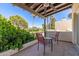 Private balcony with seating and views of green grass, tall trees, and a clear sky at 1036 N Sierra Hermosa Dr, Litchfield Park, AZ 85340