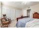 Bright bedroom featuring carpeted floors, a ceiling fan, and a set of full mirrored closet doors at 1036 N Sierra Hermosa Dr, Litchfield Park, AZ 85340
