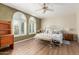 Bright bedroom with arched windows, shutters, a ceiling fan, and a decorative wrought iron bed at 1036 N Sierra Hermosa Dr, Litchfield Park, AZ 85340