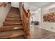 Entryway with wood stairs, wood railing and view into living room at 1036 N Sierra Hermosa Dr, Litchfield Park, AZ 85340