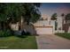Inviting two-story home with a well-manicured lawn, mature shade tree and spacious two car garage at 1036 N Sierra Hermosa Dr, Litchfield Park, AZ 85340
