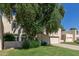 Charming two-story home with a well-manicured lawn, mature shade tree, and a private driveway at 1036 N Sierra Hermosa Dr, Litchfield Park, AZ 85340