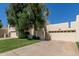 Lovely home with a two-car garage, mature landscaping, and well-maintained front yard at 1036 N Sierra Hermosa Dr, Litchfield Park, AZ 85340