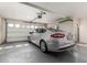 Attached garage with a silver sedan parked inside, visible garage door mechanism and storage shelf at 1036 N Sierra Hermosa Dr, Litchfield Park, AZ 85340