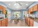 Bright kitchen featuring a breakfast nook, wood cabinets, and granite countertops at 1036 N Sierra Hermosa Dr, Litchfield Park, AZ 85340