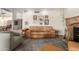 Spacious living room featuring a stone fireplace, and an area rug at 1036 N Sierra Hermosa Dr, Litchfield Park, AZ 85340