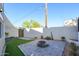 Outdoor patio with a fire pit, complemented by artificial grass and desert landscaping at 1102 W Peoria Ave # 17, Phoenix, AZ 85029