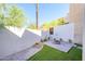Private backyard featuring artificial grass, paver patio, a fire pit, and block fencing at 1102 W Peoria Ave # 17, Phoenix, AZ 85029