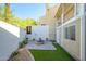 Landscaped backyard with artificial turf and a stone paver patio featuring a fire pit at 1102 W Peoria Ave # 17, Phoenix, AZ 85029