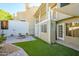 Backyard features green turf, a paver patio, and a fire pit, great for enjoying the outdoors at 1102 W Peoria Ave # 17, Phoenix, AZ 85029