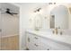 Bathroom featuring double vanity, white cabinetry, modern fixtures, and framed mirrors at 1102 W Peoria Ave # 17, Phoenix, AZ 85029