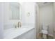Bathroom featuring stylish gold fixtures, a vanity, toilet, and ample storage at 1102 W Peoria Ave # 17, Phoenix, AZ 85029