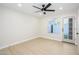 Bright bedroom features light flooring, fan, and backyard access at 1102 W Peoria Ave # 17, Phoenix, AZ 85029