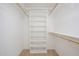 Walk-in closet with adjustable shelving and wooden rods to keep your wardrobe organized at 1102 W Peoria Ave # 17, Phoenix, AZ 85029