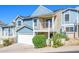 Charming two-story home featuring a white garage door, second story balcony, and professional landscaping at 1102 W Peoria Ave # 17, Phoenix, AZ 85029
