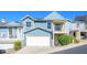 Charming two-story home featuring a white garage door and second story balcony at 1102 W Peoria Ave # 17, Phoenix, AZ 85029