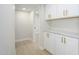 Hallway with white storage cabinets featuring stylish hardware and stone countertops at 1102 W Peoria Ave # 17, Phoenix, AZ 85029