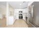 Modern kitchen with stainless steel appliances, white cabinets, and bright countertops at 1102 W Peoria Ave # 17, Phoenix, AZ 85029