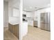 Open kitchen with white cabinets, stainless steel appliances, and modern island at 1102 W Peoria Ave # 17, Phoenix, AZ 85029