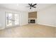 Open-concept living room with fireplace, light wood floors, recessed lighting, and double doors to the outside at 1102 W Peoria Ave # 17, Phoenix, AZ 85029