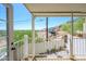 Covered patio with white railing overlooking a view with greenery, a hillside, and an RV at 1102 W Peoria Ave # 17, Phoenix, AZ 85029
