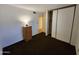 Bedroom featuring carpet, a closet, neutral paint, and featuring a vintage wooden lamp and cabinet at 11216 N 52Nd Ave, Glendale, AZ 85304