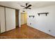 Bedroom with hardwood floors, ceiling fan, vintage light fixture and lots of natural light at 11216 N 52Nd Ave, Glendale, AZ 85304