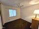 Cozy bedroom with natural light, ceiling fan, neutral walls and classic brown carpeting at 11216 N 52Nd Ave, Glendale, AZ 85304