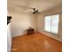 Bedroom with hardwood floors, ceiling fan, vintage light fixture and lots of natural light at 11216 N 52Nd Ave, Glendale, AZ 85304