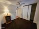 Bedroom featuring carpet, ceiling fan, a closet, neutral paint and a vintage wooden lamp and cabinet at 11216 N 52Nd Ave, Glendale, AZ 85304
