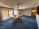Bright dining area with sliding glass doors, a ceiling fan, and a classic dining set with upholstered chairs at 11216 N 52Nd Ave, Glendale, AZ 85304
