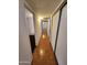 Hallway with sliding closet doors and wood-look floors at 11216 N 52Nd Ave, Glendale, AZ 85304