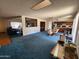 Open-concept living space with blue carpet, providing a seamless transition between living and dining areas at 11216 N 52Nd Ave, Glendale, AZ 85304