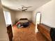 Bright main bedroom with ceiling fan, wood-look flooring, and sliding door to the patio at 11216 N 52Nd Ave, Glendale, AZ 85304