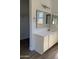 Bright bathroom with a dual-sink vanity, framed mirror, and modern fixtures at 12586 W Amelia Ave, Avondale, AZ 85392