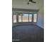This bedroom features new carpeting and a bay window looking out to the backyard at 12586 W Amelia Ave, Avondale, AZ 85392